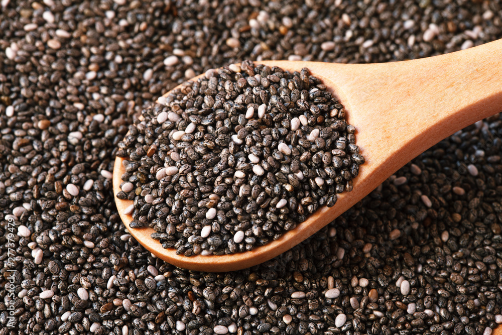 chia seeds in wooden spoon, macro, healthy food supplements, top view chia seeds in wooden spoon, macro, healthy food supplements, top view