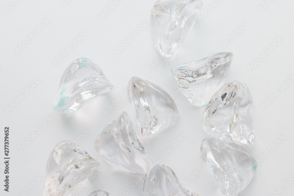 Scattered crystals on white background, beautiful gems Scattered crystals on white background, beautiful gems