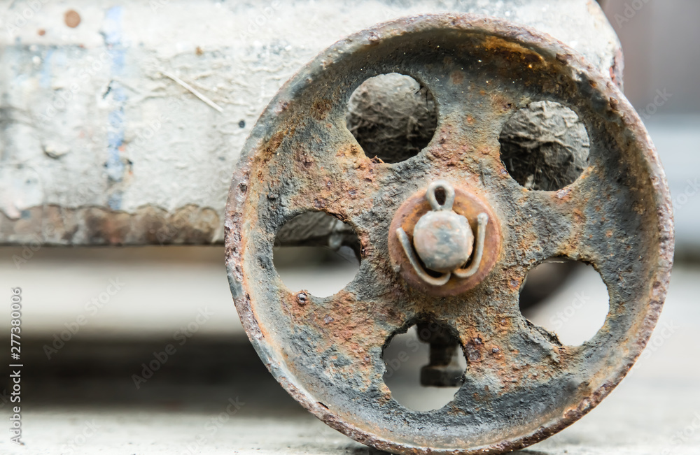 old rusty metal wheel closeup detail background