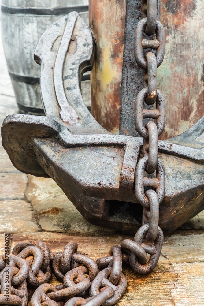 big old rusty anchor on dock closeup view big old rusty anchor on dock closeup view