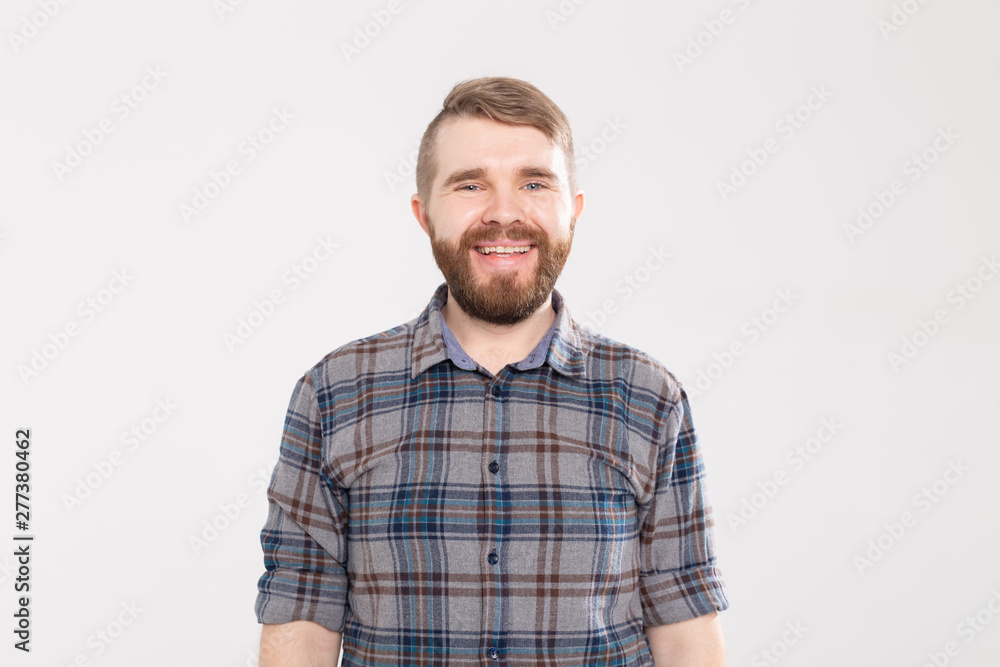Handsome happy bearded man smiling and laughing on white background Handsome happy bearded man smiling and laughing on white background