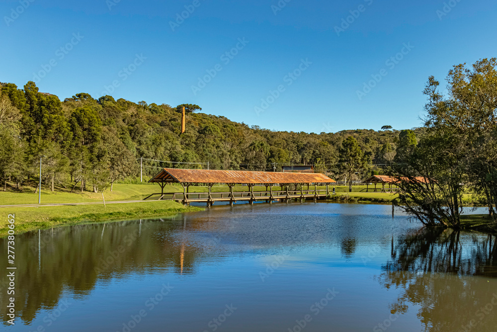 Two covered bridges in a park on a sunny morning