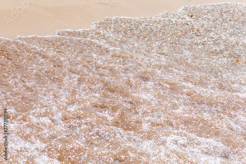 Fototapeta Naklejka Na Ścianę i Meble -  Clear soft wave of sea or ocean on sandy beach. Background.