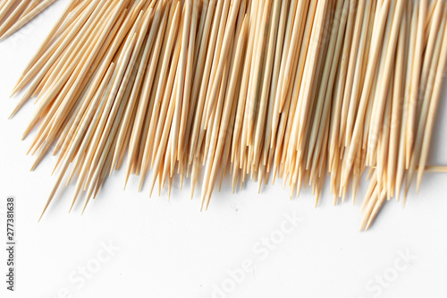 Pile of scattered toothpicks on white background