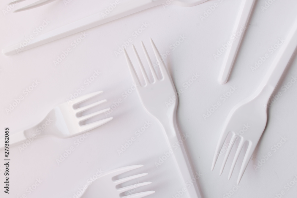 White plastic forks flat lay on white background White plastic forks flat lay on white background