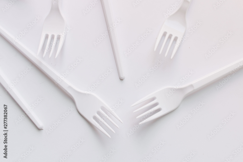 White plastic forks flat lay on white background