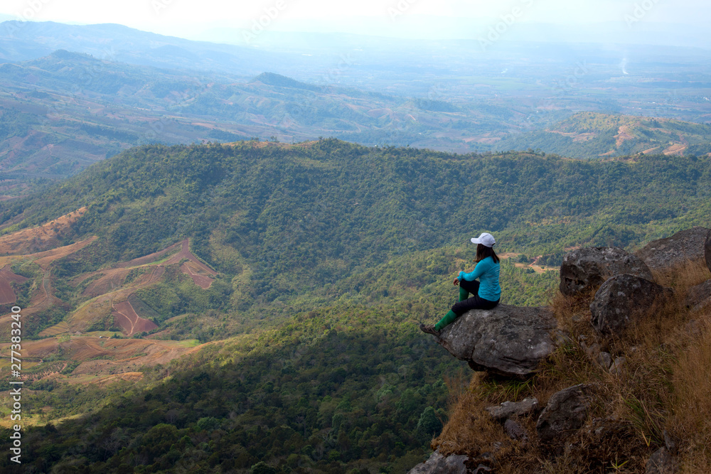 Woman enjoy with beautiful view on the top of mountain 