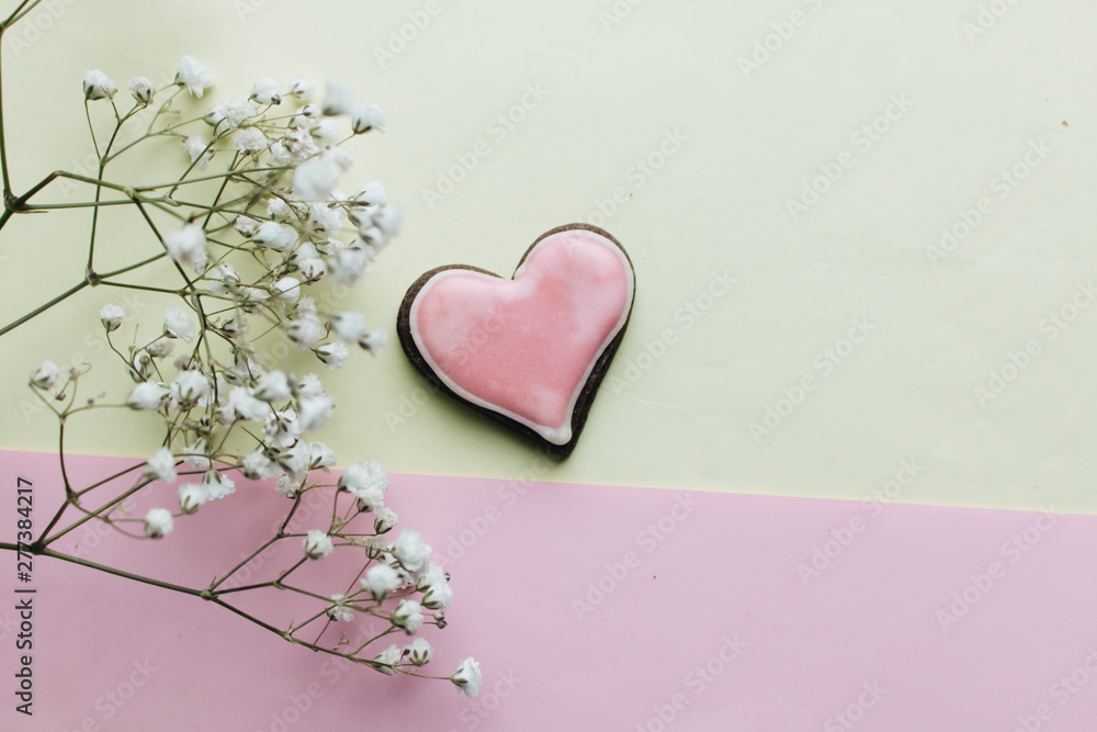 Cookie in heart shape with red glaze and white flowers , valentines day concept, love heart Cookie in heart shape with red glaze and white flowers , valentines day concept, love heart