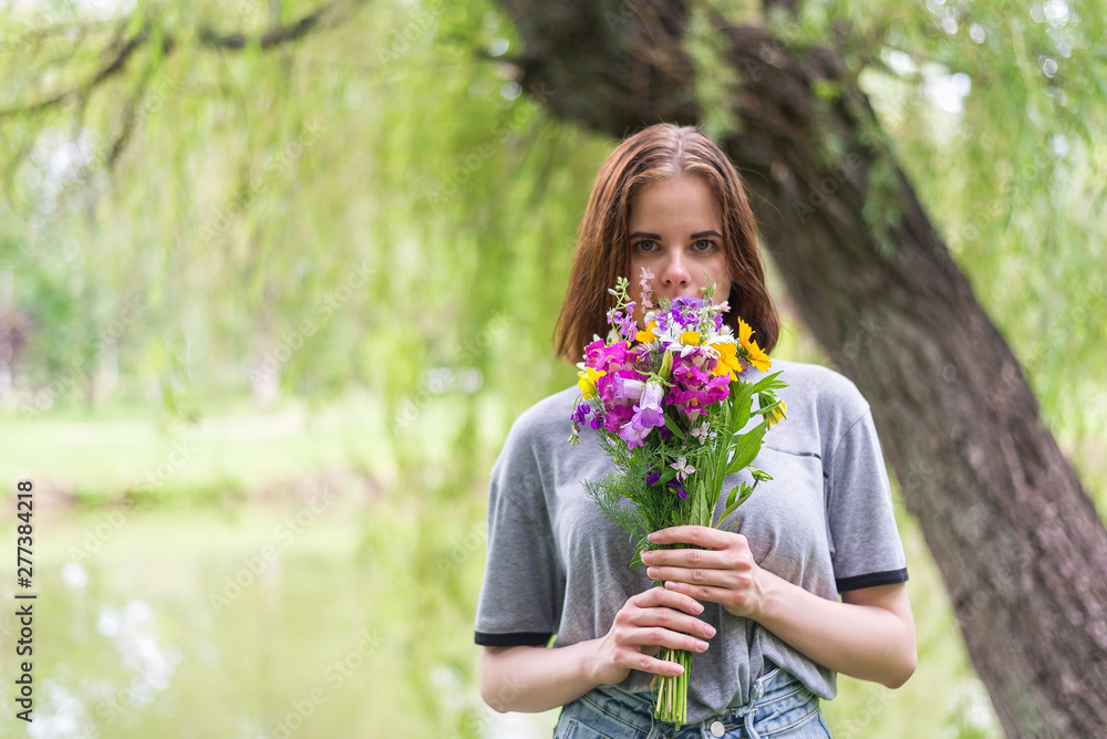 Beautiful girl with a bouquet of wild flowers. Beautiful girl with a bouquet of wild flowers.