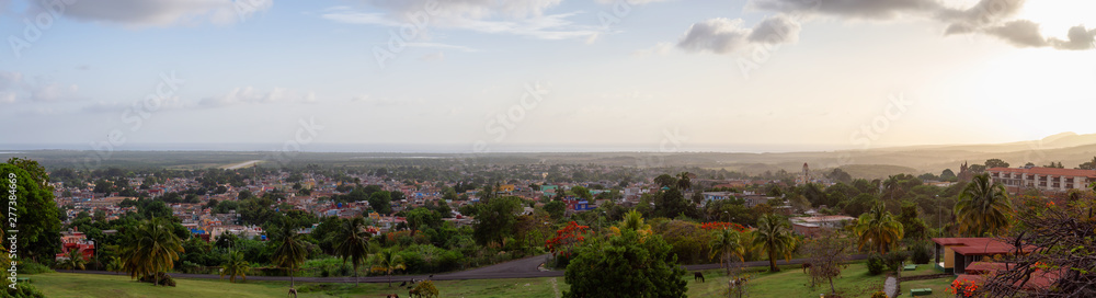 Aerial panoramic view of a small touristic Cuban Town during a colorful and cloudy sunset. Taken in Trinidad, Cuba.