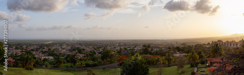 Aerial panoramic view of a small touristic Cuban Town during a colorful and cloudy sunset. Taken in Trinidad, Cuba.