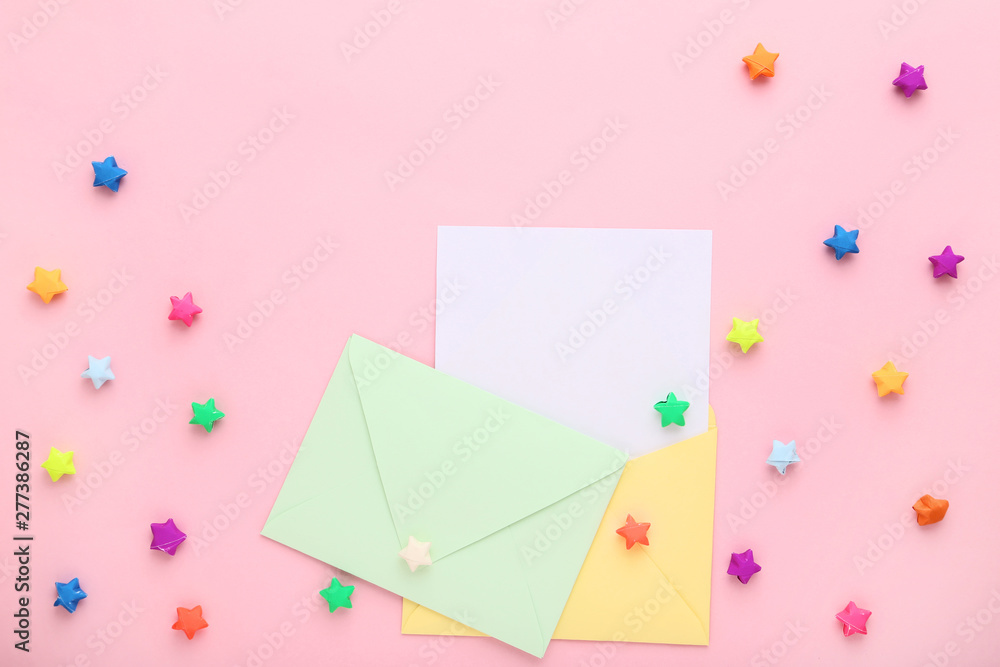 Envelopes with colorful paper stars on pink background Envelopes with colorful paper stars on pink background