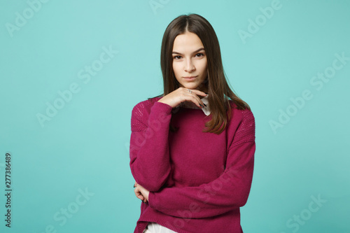 Young brunette woman girl in casual clothes posing isolated on blue green turquoise background studio portrait. People sincere emotions lifestyle concept. Mock up copy space. put hand prop up on chin
