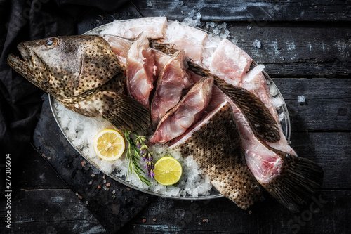 Fotografia Sea delicacies. Fresh seafood. Fish Grouper