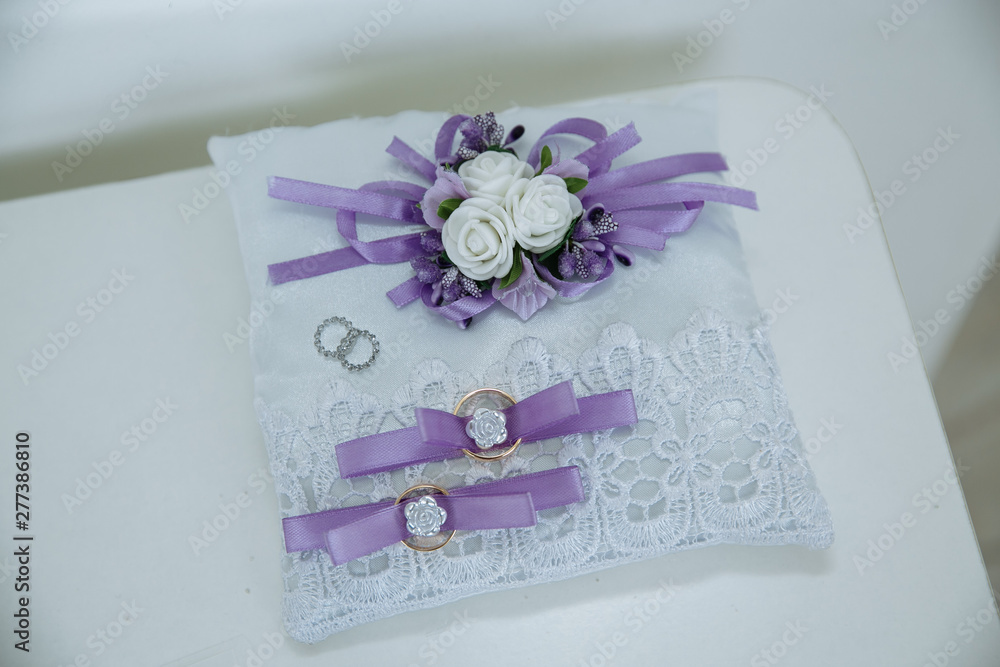 wedding rings on a white background in a wedding decoration wedding rings on a white background in a wedding decoration