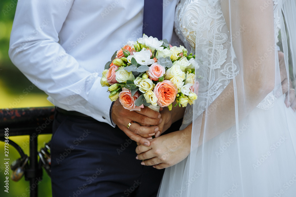 a bouquet of flowers in the hands of the bride a bouquet of flowers in the hands of the bride