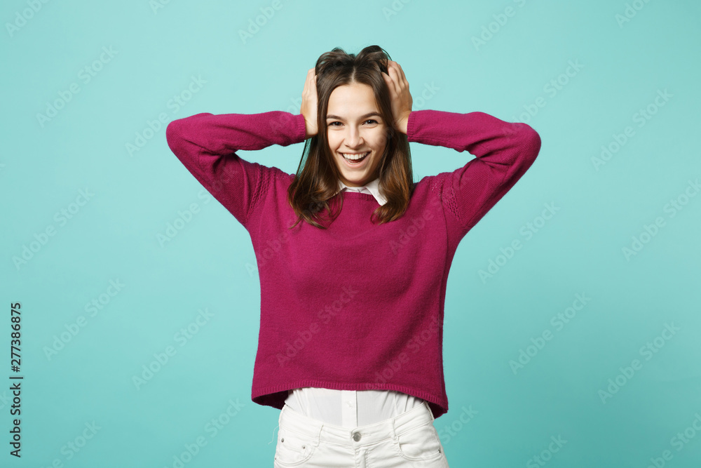 Young brunette woman girl in casual clothes posing isolated on blue green turquoise wall background studio portrait. People sincere emotions lifestyle concept. Mock up copy space. Looking camera smile Young brunette woman girl in casual clothes posing isolated on blue green turquoise wall background studio portrait. People sincere emotions lifestyle concept. Mock up copy space. Looking camera smile