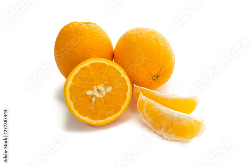 Fresh orange whole, half, and slices on white background