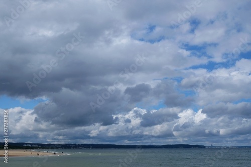 Poland  Gdansk  Baltic Sea - walking people on Jelitkowo beach in cloudy day with amazing dramatic clouds