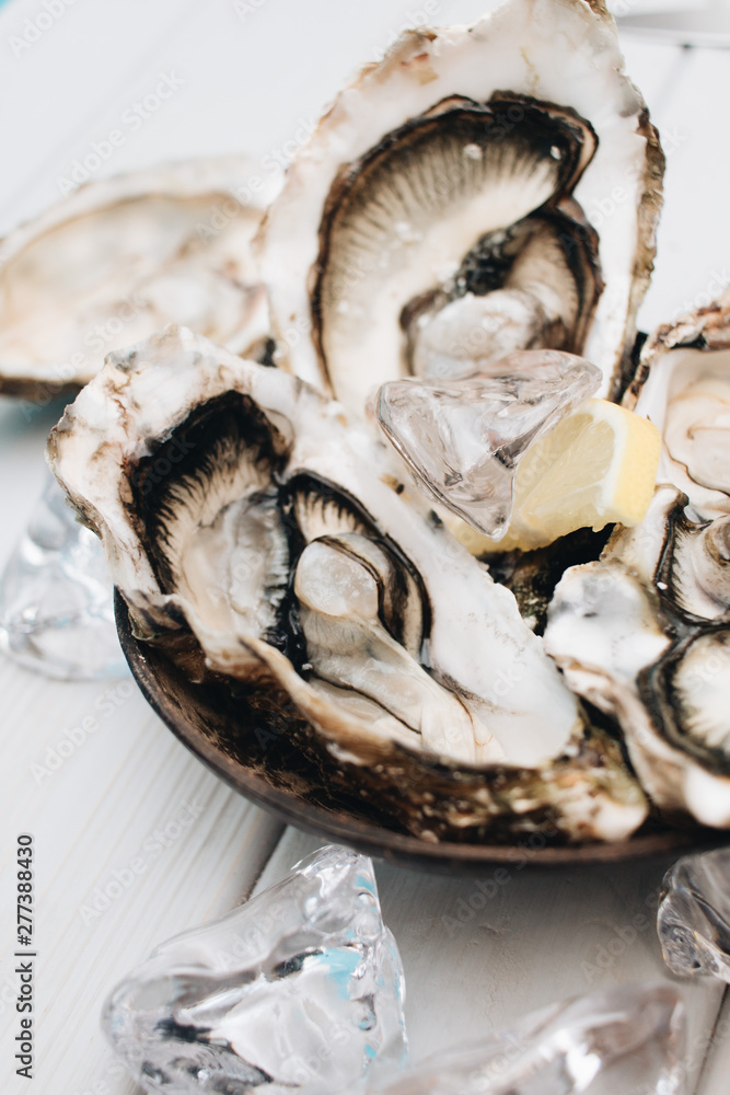 Delicious oysters with lemon, seafood delicacy Delicious oysters with lemon, seafood delicacy