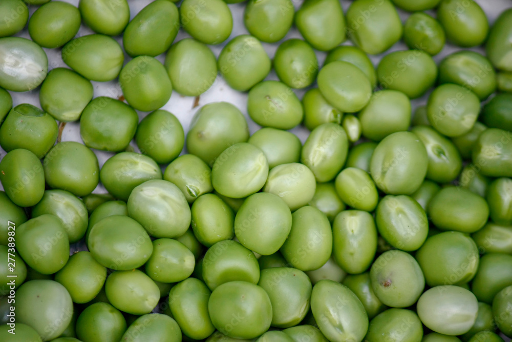 Background with fresh organic green peas. Close-up view from above. Background with fresh organic green peas. Close-up view from above.