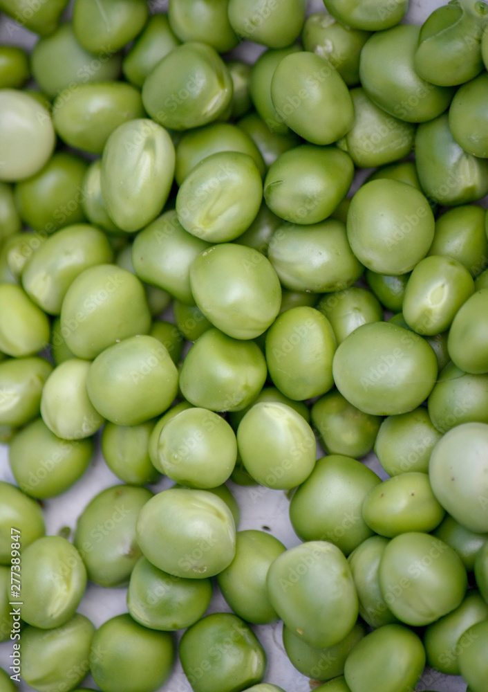 Background with fresh organic green peas. Close-up view from above. Background with fresh organic green peas. Close-up view from above.