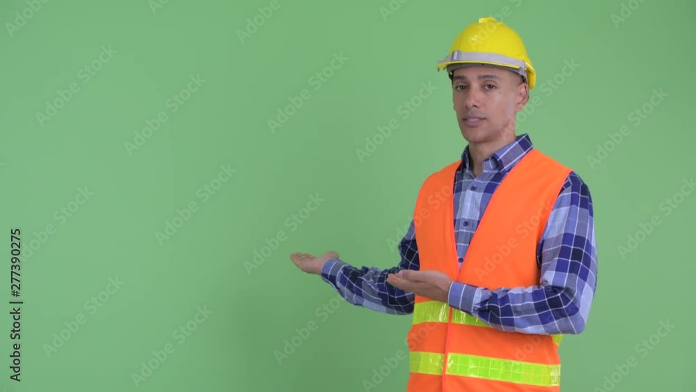 Stressed multi ethnic man construction worker showing to back Stressed multi ethnic man construction worker showing to back