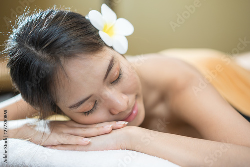 Beautiful young woman in spa salon, Body care. Spa body massage woman hands treatment. Woman having massage in the spa salon