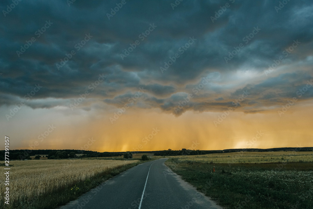 road to sunset and the oncoming thunderstorm