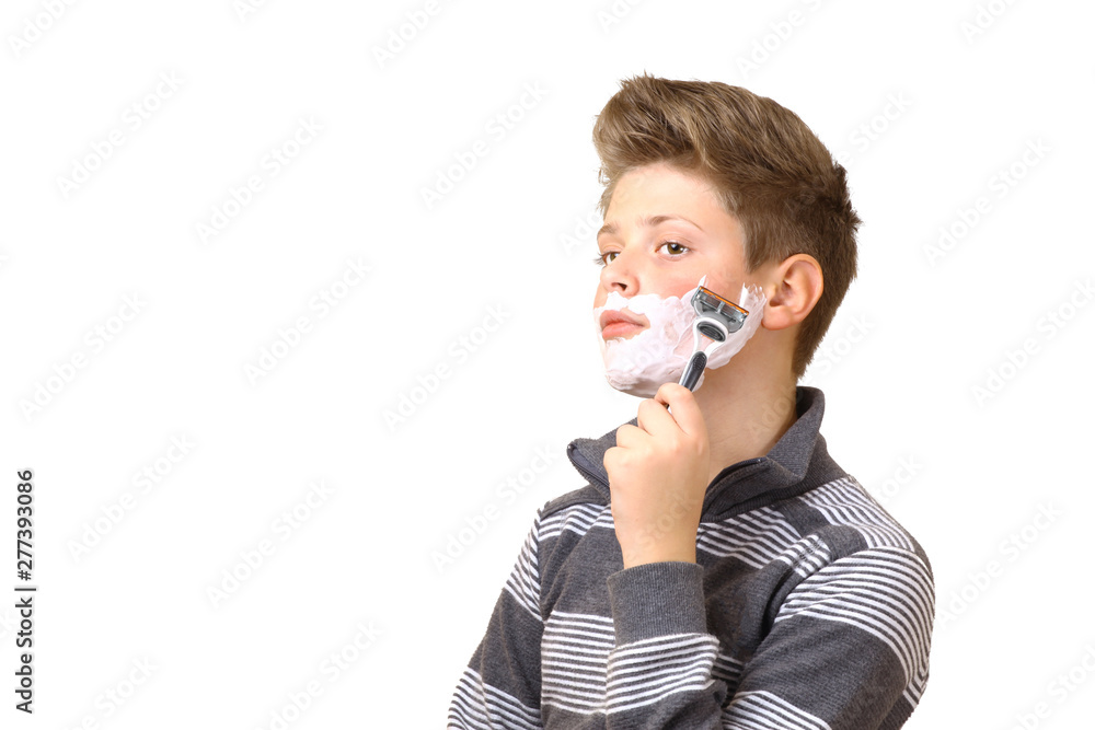 Young guy, a teenager is shaving. Isolated on white background. In the hands of a razor. Foam on the beard. Place for text. Young guy, a teenager is shaving. Isolated on white background. In the hands of a razor. Foam on the beard. Place for text.
