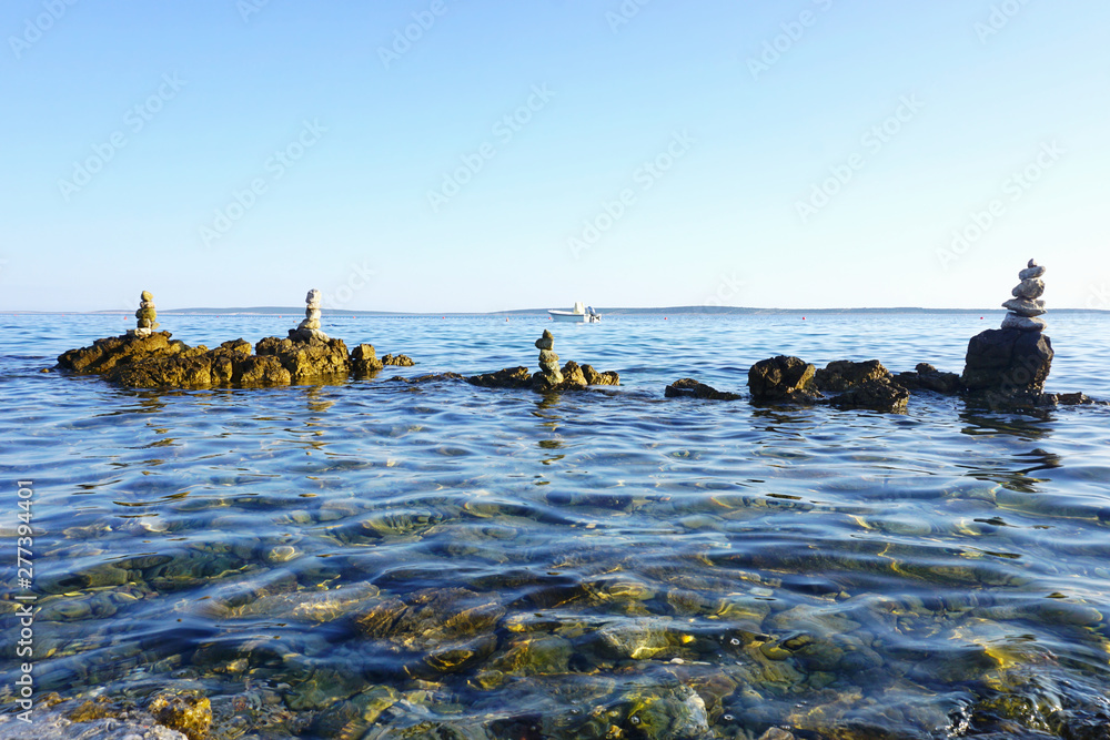 Beautiful seascape with stacked stones in the water
