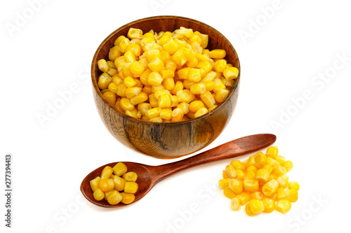 Corn seeds in a wooden spoon and cup (plate) isolated on white background