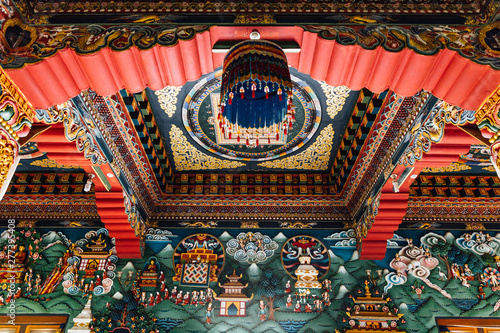 Decorated ceiling that tell about Buddha story in Bhutanese art inside The Royal Bhutanese Monastery in Bodh Gaya, Bihar, India.