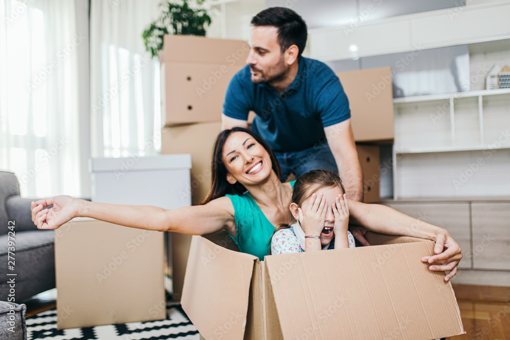 Family unpacking cardboard boxes at new home. Family unpacking cardboard boxes at new home.
