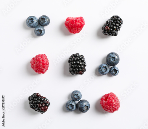 Flat lay composition with berries on white background, space for text