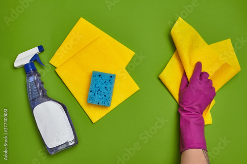 Photos Detergents and cleaning accessories on a green background