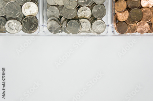 Organized loose coin change on top side  blank empty room space for text bottom