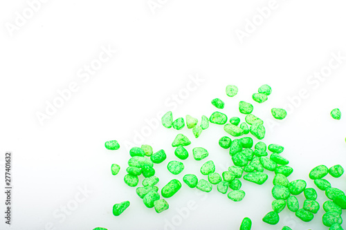 Green pebbles stone with empty copyspace area for slogan or advertising text message  over isolated white background.
