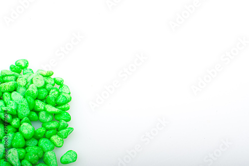 Green pebbles stone with empty copyspace area for slogan or advertising text message, over isolated white background.