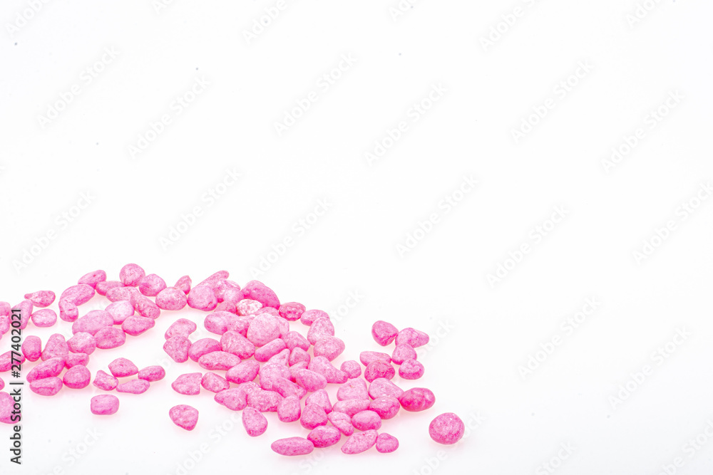 Pink pebbles stone with empty copyspace area for slogan or advertising text message, over isolated white background. Pink pebbles stone with empty copyspace area for slogan or advertising text message, over isolated white background.