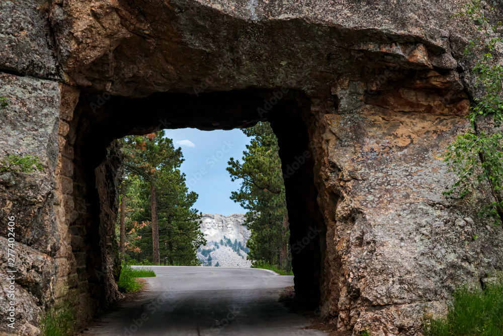 Mount Rushmore framed by tunnel on Iron Mountain Road in the Black Hills of South Dakota, USA