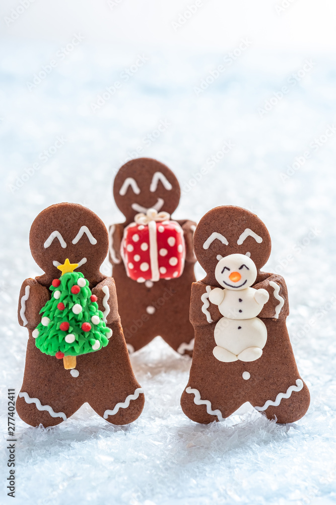 Funny Gingerbread cookie men with tiny marzipan snowman Funny Gingerbread cookie men with tiny marzipan snowman
