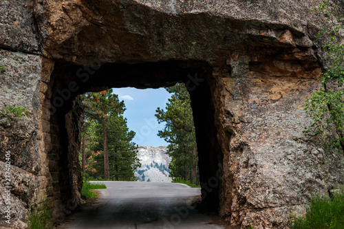Fototapeta Naklejka Na Ścianę i Meble -  Mount Rushmore framed by tunnel on Iron Mountain Road in the Black Hills of South Dakota, USA