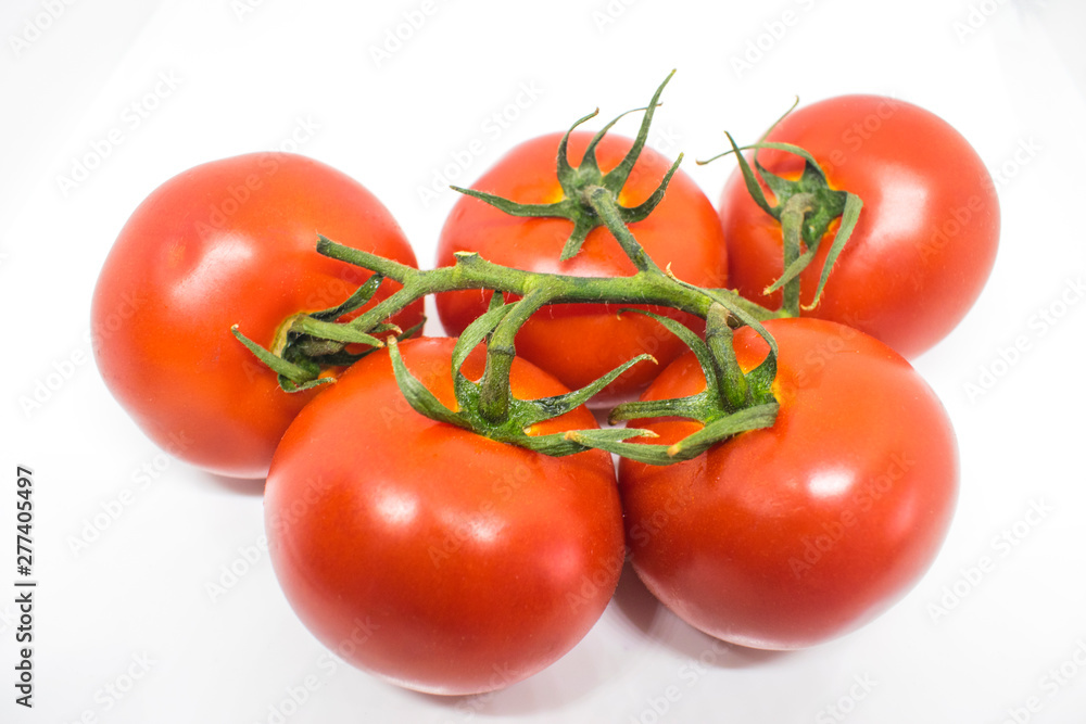 Red tomatoes on a branch. Vegetables isolated Red tomatoes on a branch. Vegetables isolated