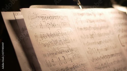 Camera moving over a music sheet showing notes of a tango instrumental piece.