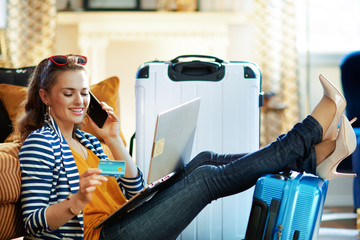 woman with credit card booking tickets and using call center