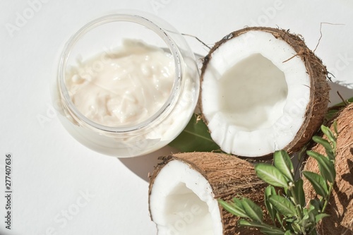 Coconut and cream in a jar with a green twig