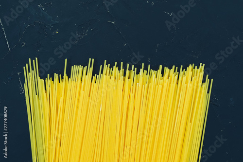 Italian vermicelli spaghetti on a black background.