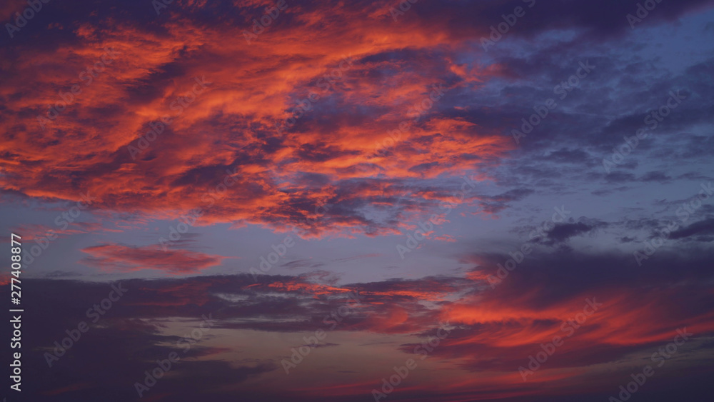 evening sky with thunderclouds. Natural view with blue and red, magenta colors clouds.
