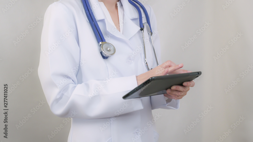 The doctor in a white coat working with the tablet. static The doctor in a white coat working with the tablet. static